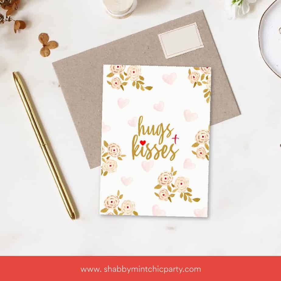 Free Printable Hugs and Kisses card on top of craft paper envelope mock up of greeting card
