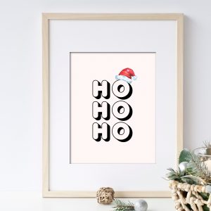 Christmas wall art with the saying HO HO HO with Santa hat on the letter O