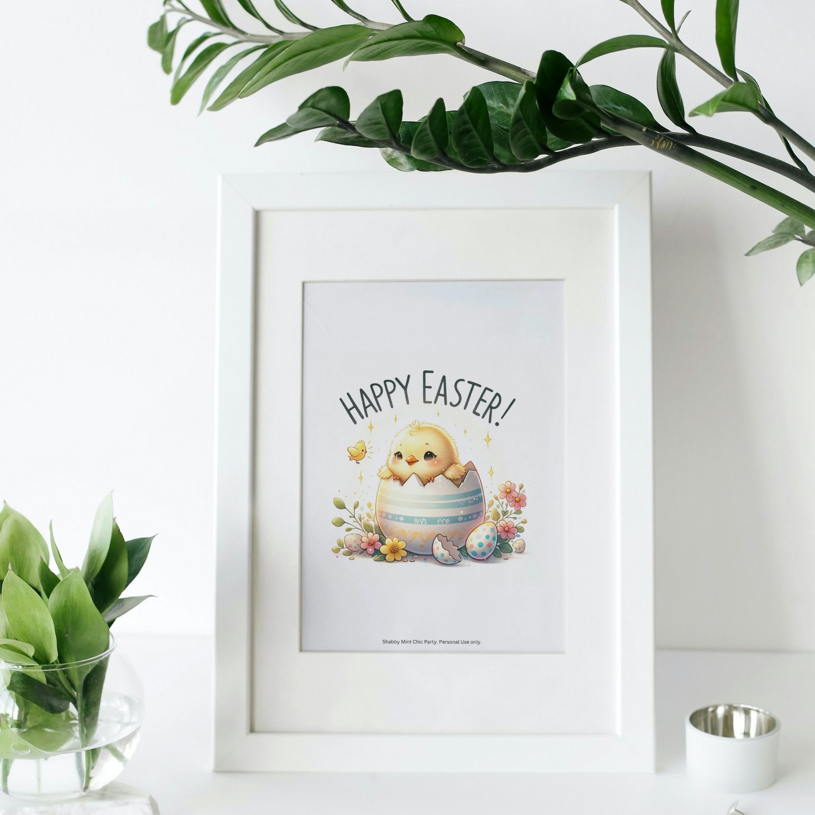 Easter Printable in Frame. Illustration of a cute chick hatched from an Easter egg, surrounded by colorful flowers, with the words 'Happy Easter' on top.